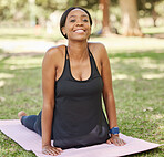 Cobra stretching, woman and portrait in park for exercise, workout and relax training in nature. Happy black girl, yoga and flexible body fitness in garden of wellness, healthy goals  and zen energy