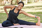 Black woman, portrait and stretching legs for park exercise, workout and relax training in nature. Happy girl, yoga athlete and warm up body in garden for fitness, wellness and healthy sports goals 