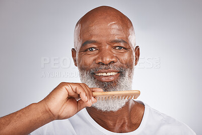 Buy stock photo Elderly, black man with comb for beard, beauty and grooming with hygiene and cosmetic care against studio background. Hair care mockup, brush body hair and face portrait with treatment and cosmetics