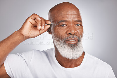 Buy stock photo Senior black man, eyebrow and tweezer for self care and grooming for clean, glow and fresh skin and face. Portrait of African male for facial hair removal or epilation on grey studio background