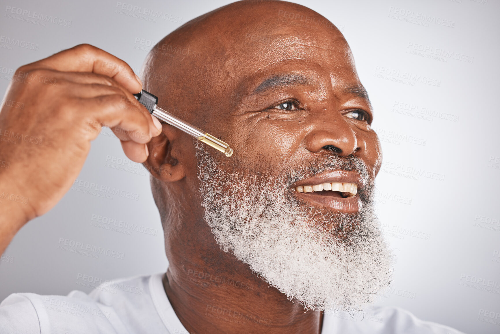 Buy stock photo Skincare, wellness and man with a face serum in a studio for a healthy, cosmetic and natural routine. Beauty, cosmetics and African male with a facial oil treatment isolated by a gray background.