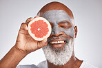 Skincare, face mask or happy old man with grapefruit marketing or advertising natural vegan diet for glowing skin. Cream, smile, senior black man with beauty or healthy anti aging facial cosmetics