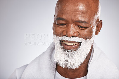 Buy stock photo Face, shaving cream and happy black man with smile on beard, skincare treatment on grey background. Health, mock up and facial hair, mature man morning shave routine with space for product placement.
