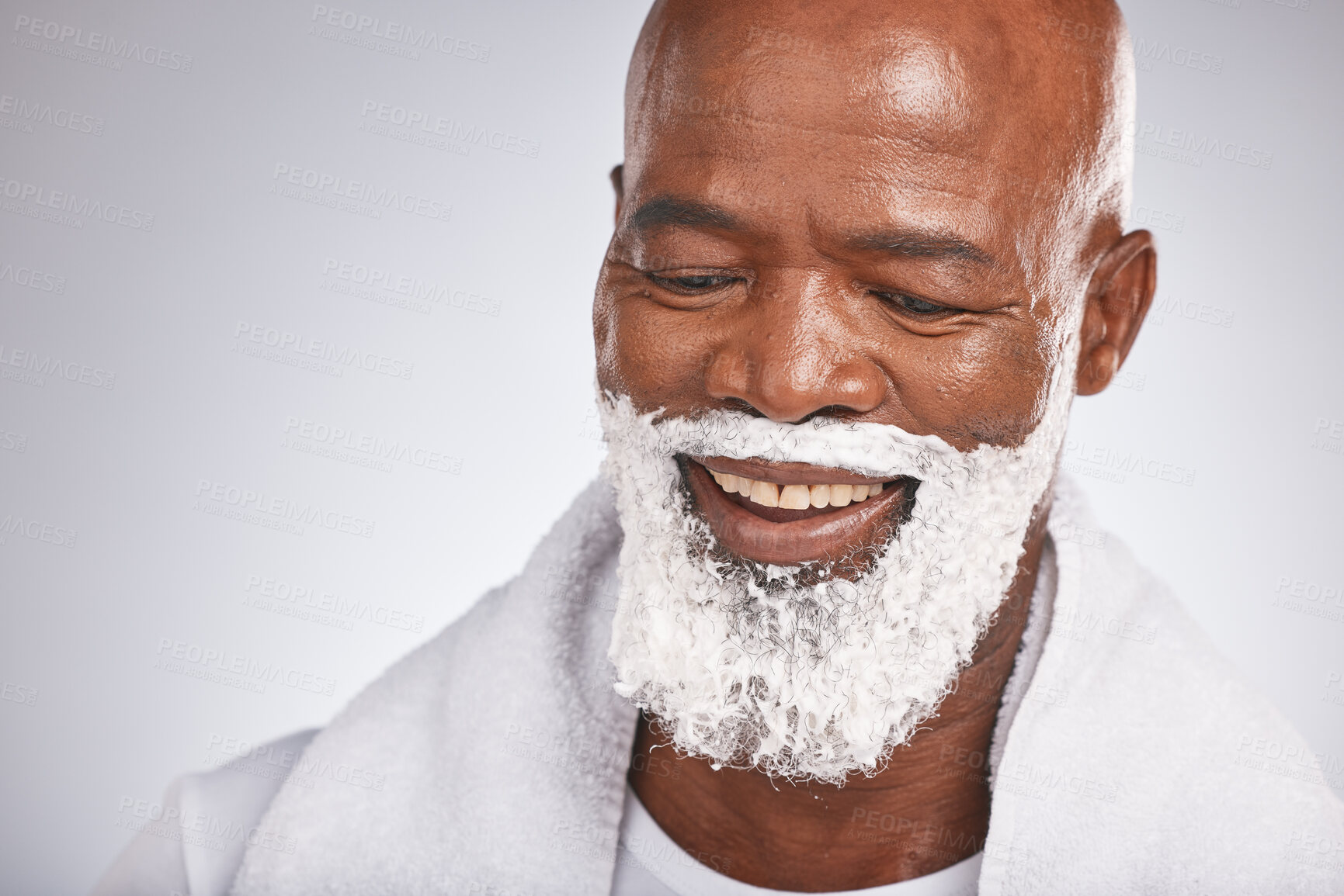 Buy stock photo Face, shaving cream and happy black man with smile on beard, skincare treatment on grey background. Health, mock up and facial hair, mature man morning shave routine with space for product placement.