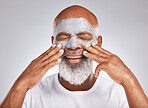 Skincare, hands or old man with facial cream marketing or advertising luxury beauty product for self care. Studio background, cosmetics or elderly black man with a happy smile applying face mask