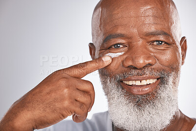 Buy stock photo Black man, beauty and face cream for skincare of senior in studio for self care with dermatology and cosmetic product. Portrait of happy male with lotion on skin for glow, health and wellness on grey