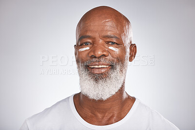 Buy stock photo Facial cream, beauty and skincare of senior man in studio for self care with dermatology and cosmetics product on skin. Portrait of happy black male with sunscreen or lotion for glow and moisturizer
