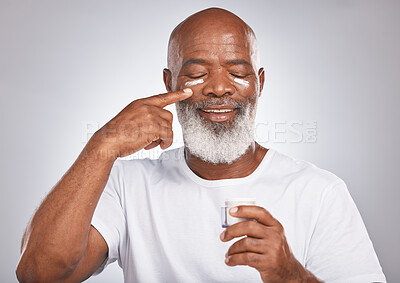 Buy stock photo Beauty, facial cream and black man with dermatology or cosmetics for self care with skincare container. Face of happy African male with skin product on grey studio background for wellness and a glow