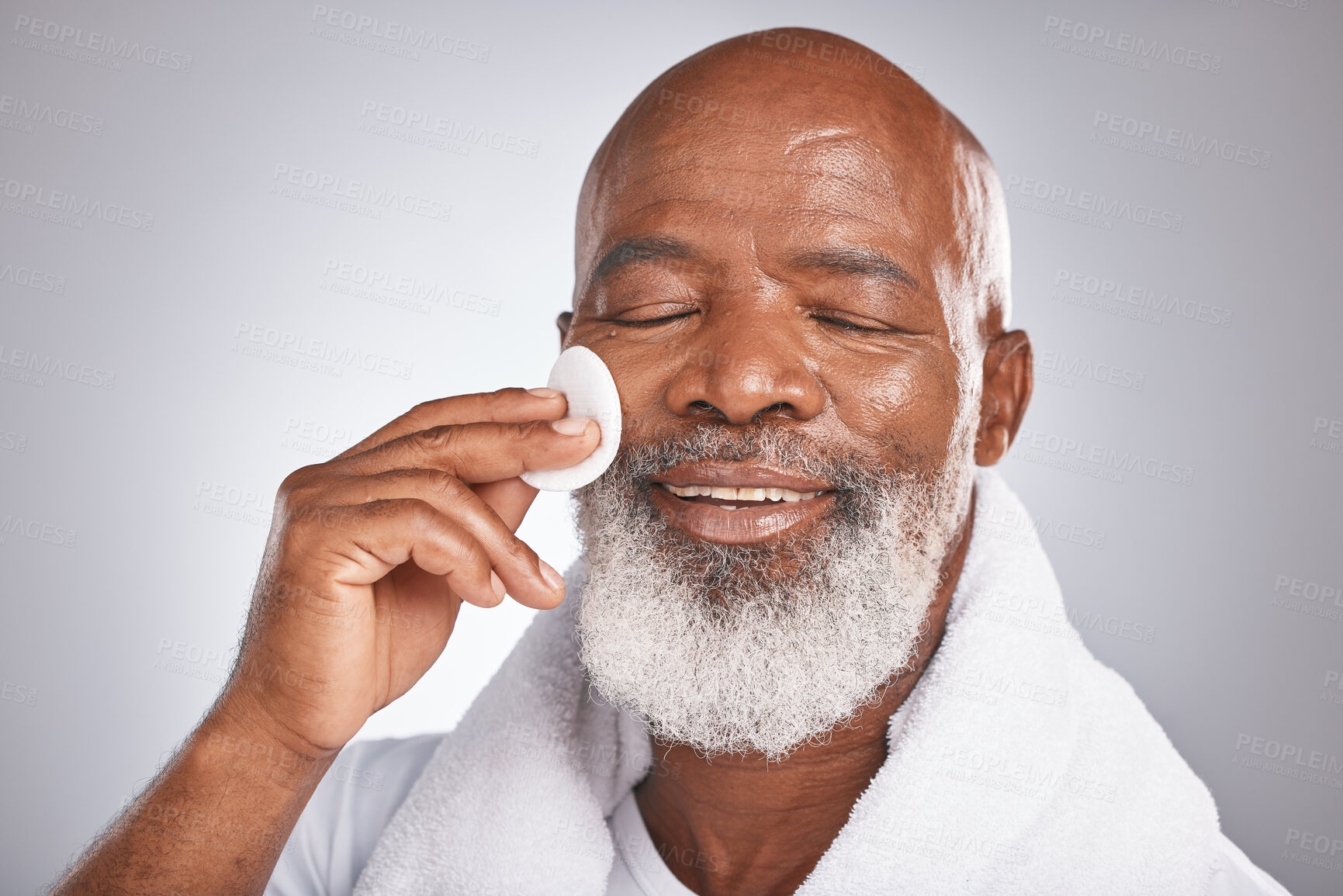 Buy stock photo Black man, face and skincare with cotton for self care with  dermatology and cosmetics for detox, glow and clean skin. Headshot of African male on studio background for facial beauty spa treatment