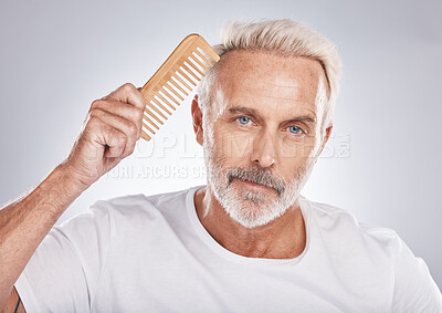 Buy stock photo Mature man, portrait and hair comb on studio background from barbershop, salon skincare and healthy cosmetics. Face, male model and brushing hair care for fashion, shampoo product and morning routine