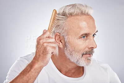 Buy stock photo Senior man, hair comb and brush on studio background for beauty, barber salon and cosmetics. Face of male model, brushing hairstyle and fashion for manly grooming, hair care and fresh morning routine