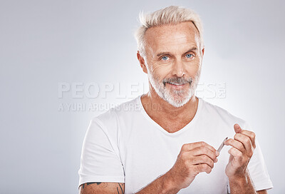 Buy stock photo Portrait, nail file and grooming with a man in studio on gray background mockup for beauty, filing his finger nails. Manicure, wellness and cosmetics with a male taking care of his personal hygiene