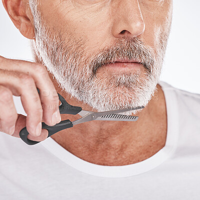 Buy stock photo Trim, beard and senior man with scissors for grooming, facial cleaning and morning routine on a studio background. Barber, care and face of a senior model trimming hair for a clean beauty look
