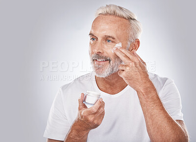Buy stock photo Skincare, beauty and face cream on senior man on white background for spa, wellness and dermatology. Cosmetics, grooming and elderly male with anti aging beauty products, facial treatment and lotion