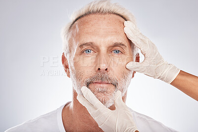 Buy stock photo Man face, hands or cosmetic surgery gloves on studio background for skincare collagen, medical dermatology or anti aging grooming. Portrait, plastic surgeon or mature patient check for facial change
