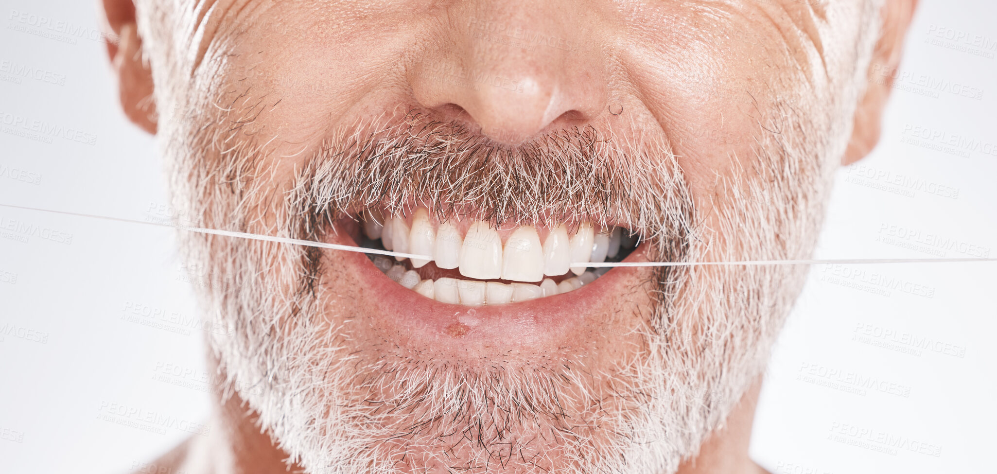 Buy stock photo Dental, floss and mouth of senior man in studio isolated on a gray background. Hygiene, cleaning and elderly male model with product flossing teeth for oral wellness, tooth care and healthy gums.