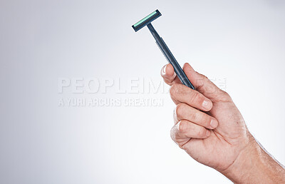 Buy stock photo Grooming, shaving and hand with a razor for body hair, hygiene and clean shave on a studio background with mockup. Cleaning, equipment and model with a product for trimming hairs for wellness