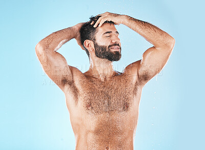 Buy stock photo Shampoo, keratin and haircare with a man model cleaning his hair for hygiene in studio on a blue background. Water, wet and treatment with a handsome muscular male washing his head in the bathroom