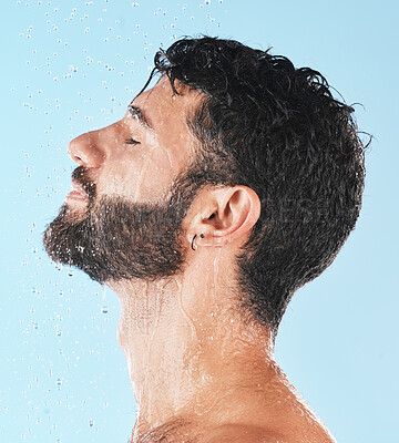 Buy stock photo Shower, man with water and face profile with cleaning and hygiene, grooming and skincare against blue studio background. Clean with water drops, facial with natural treatment and cosmetic mockup