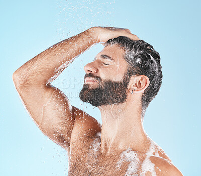 Buy stock photo Face, water splash and shampoo shower of man in studio isolated on a blue background. Water drops, hair care hygiene and male model washing, cleaning or bathing for healthy skin, wellness or skincare