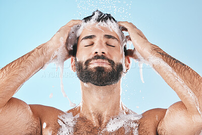 Buy stock photo Shower, man and cleaning for skincare, wellness and hygiene on blue studio background. Arabic male, guy and wash face, hair and hydration for self care, health or body care for cleanliness or routine