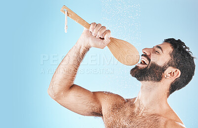 Buy stock photo Bathroom, singing and washing with a man model in studio on a blue background using a loofah to sing. Water, showering and hygiene with a handsome male wet while cleaning for personal body care