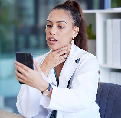 Buy stock photo Phone, video call and doctor doing a consultation online for healthcare in her office at the hospital. Communication, technology and female medical worker consulting on a cellphone in medicare clinic