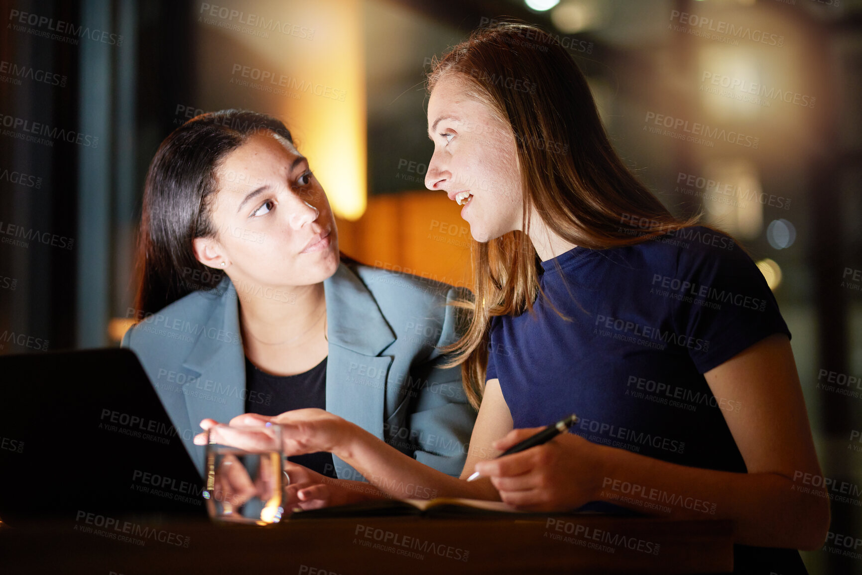 Buy stock photo Business woman, laptop and talking at night in office planning report deadline, strategy discussion and teamwork overtime. Business people, late meeting and tech marketing training at workplace desk