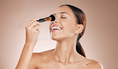 Buy stock photo Makeup, brush on face and woman with beauty cosmetics mockup and wellness against studio background. Facial, treatment and cosmetic equipment, smile and foundation application with tools and skincare