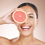 Skincare, diet glow and woman with a grapefruit, marketing health and smile for detox food on a studio background. Vitamin c, nutrition and portrait of a dermatology model with fruit for wellness