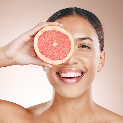 Buy stock photo Skincare, diet glow and woman with a grapefruit, marketing health and smile for detox food on a studio background. Vitamin c, nutrition and portrait of a dermatology model with fruit for wellness