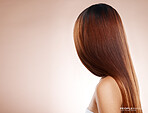 Salon, hair and back of woman in studio for hair care, hair products and cosmetics on beige background. Beauty, balayage and girl with healthy, shine and long hair for hair salon, treatment and glow