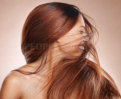 Buy stock photo Shaking hair, beauty and cosmetics of a happy woman on studio background for luxury keratin treatment with shampoo product. Headshot of female posing for salon, hairdresser and wellness mockup