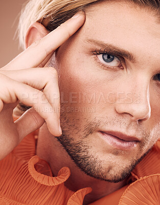 Buy stock photo LGBT, fashion and face portrait of man with orange clothes, beauty or creative style on studio background. Transgender, gay or non binary person with natural makeup, skincare glow or facial cosmetics