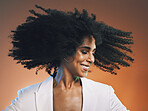 Natural hair, beauty and black woman with hair care, cosmetics and happiness against studio background. Makeup, dance and freedom with pride in curly hair texture and makeup, skincare headshot