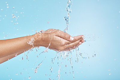 Buy stock photo Woman hands, water splash and clean wellness, skincare and personal hygiene, health and shower on studio blue background. Closeup water drops, stream and washing hands, palm and cleaning body in bath