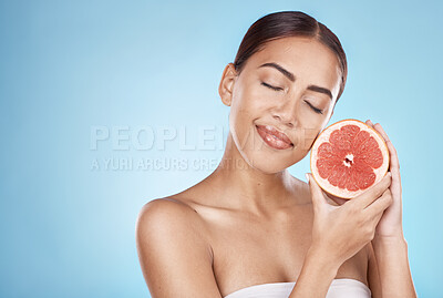 Buy stock photo Skincare, grapefruit and happy wellness woman satisfied with vitamin c body care glow treatment. Aesthetic, detox and natural cosmetic model in blue studio with beauty marketing mockup.