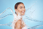 Happy woman, body skincare or water splash on blue background studio in healthcare wellness, Brazil hygiene maintenance or shower grooming. Smile portrait, beauty model or wet water drop for cleaning