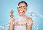 Kiwi, skincare and woman in water splash for beauty, cosmetics and cleaning advertising of vegan product in studio mockup. Young, happy model, fruit in hands and healthy glow or shine for dermatology