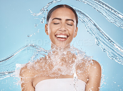 Buy stock photo Happy woman, face or water splash skincare on blue background studio in healthcare wellness, Brazil hygiene cleaning or relax grooming. Beauty model, wet or water drops shower for facial dermatology