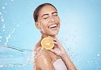 Water, lemon and woman with happy skincare, beauty or cosmetics product in studio or shower mockup for vegan advertising. Wellness model with fruit in hands and splash for healthy dermatology glow