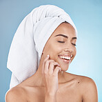 Woman, facial care and happy with towel for luxury beauty vision, salon spa cleaning and closed eyes in blue background studio. Happy model, smile and skin glow, wellness or hair care dermatology