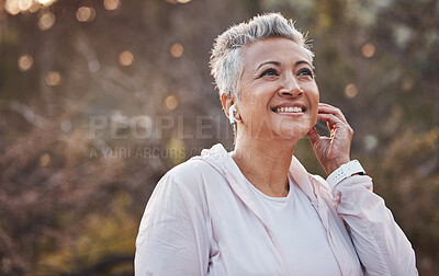 Buy stock photo Fitness, exercise and senior woman listening to music with earphones in nature while running for cardio workout outdoor. Elderly female with podcast in forest to run for healthy lifestyle and energy