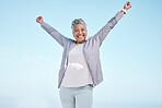 Excited senior woman with hands in air for exercise, fitness or workout portrait goals, success and achievement on blue sky mockup. Winner, freedom and healthy celebration of elderly runner in nature