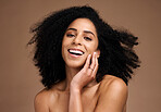 Woman, studio portrait and afro with beauty, makeup and cosmetic wellness with hands, face or natural hair. Model, skincare and facial cosmetics, self care and beauty smile by brown studio background