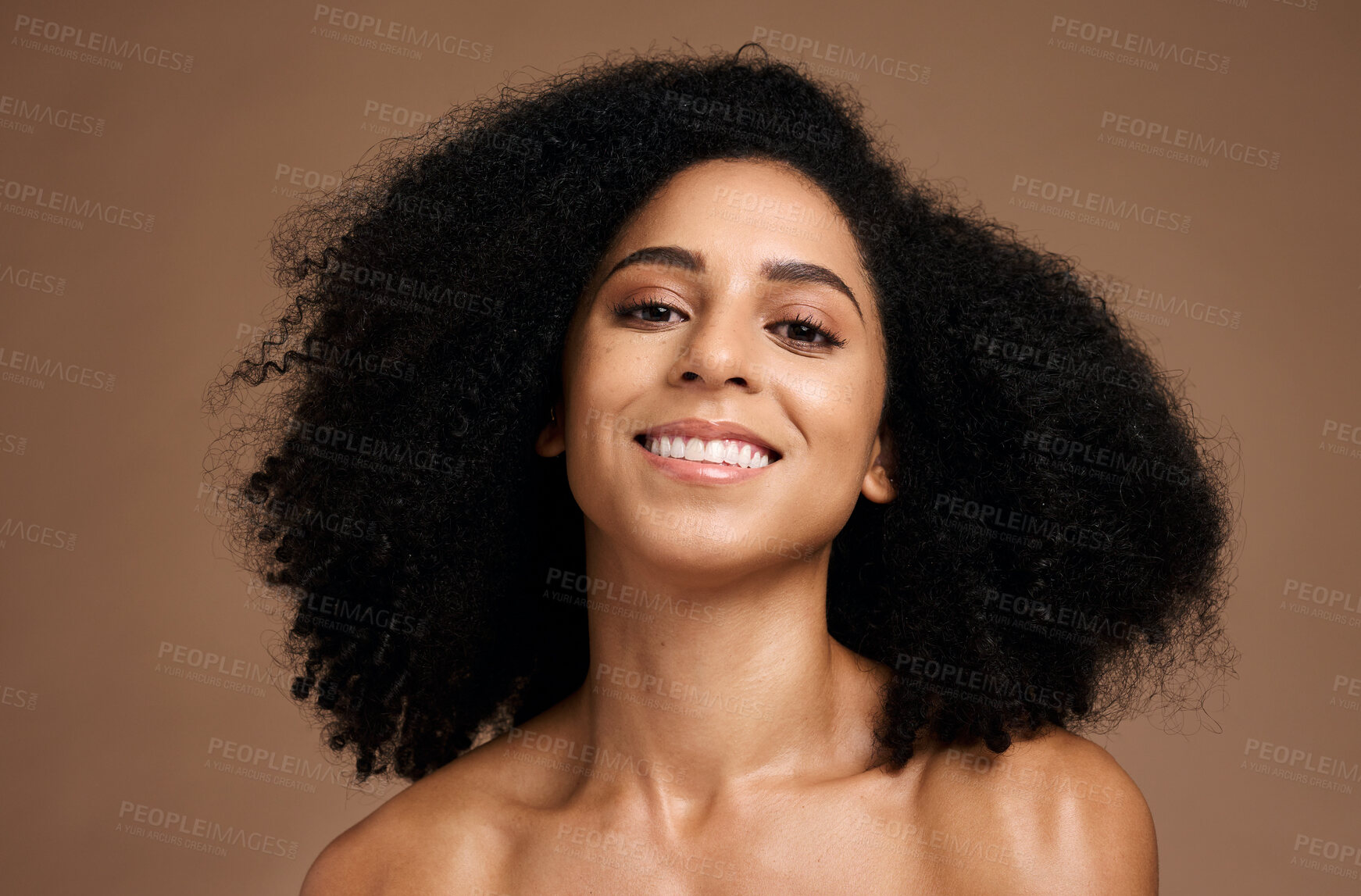 Buy stock photo Black woman, portrait and happiness for skincare wellness, natural curly hair care and cosmetics dermatology in brown background studio. African girl, smile and luxury self care beauty or body glow