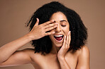 Happy black woman, hair and face with surprise and fun, hands with manicure, healthy skin and glow. Natural curly hair, hair care and cosmetic care with facial skincare against studio background