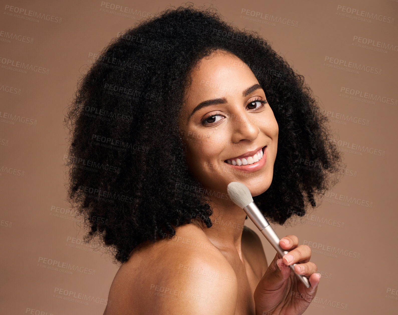 Buy stock photo Face portrait, beauty and black woman with makeup brush in studio isolated on a brown background. Skincare, cosmetics tool and happy female model with product to apply foundation for facial wellness.