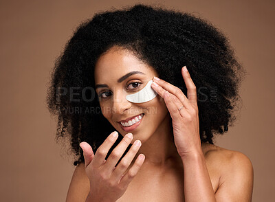 Buy stock photo Face, skincare and black woman with eye patch in studio on a brown background. Portrait, makeup and cosmetics of female model with facial collagen pad or product for anti aging, hydration or wellness