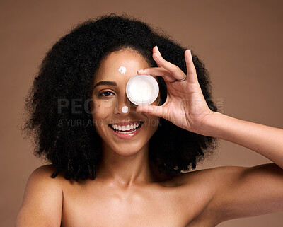 Buy stock photo Portrait, container and beauty with a model black woman in studio on a brown background for skin treatment. Face, product and skincare with an attractive young female posing to promote antiaging care